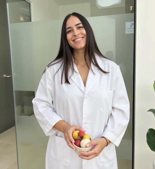 Paula Bouzian nutricionista deportivo Paula Bouzian nutricionista deportivo sonriente con un bol de frutas